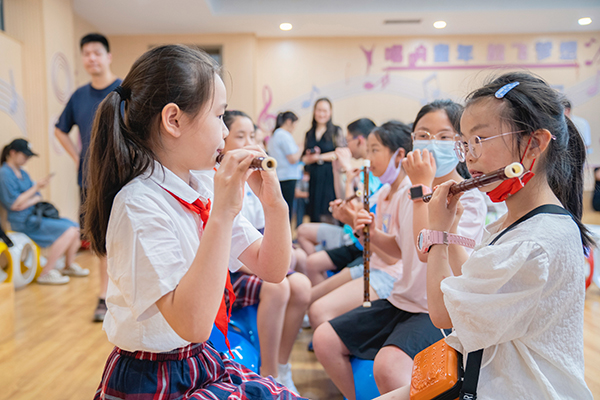 7杭州孩子教九龙孩子吹竹笛2.jpg